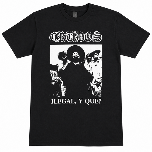 A black short-sleeve t-shirt with a white graphic print of the band Crudos. The print features the band's name in a gothic font at the top, a black-and-white photo of a man in a sombrero, and the text 'ILEGAL, Y QUE?' at the bottom.